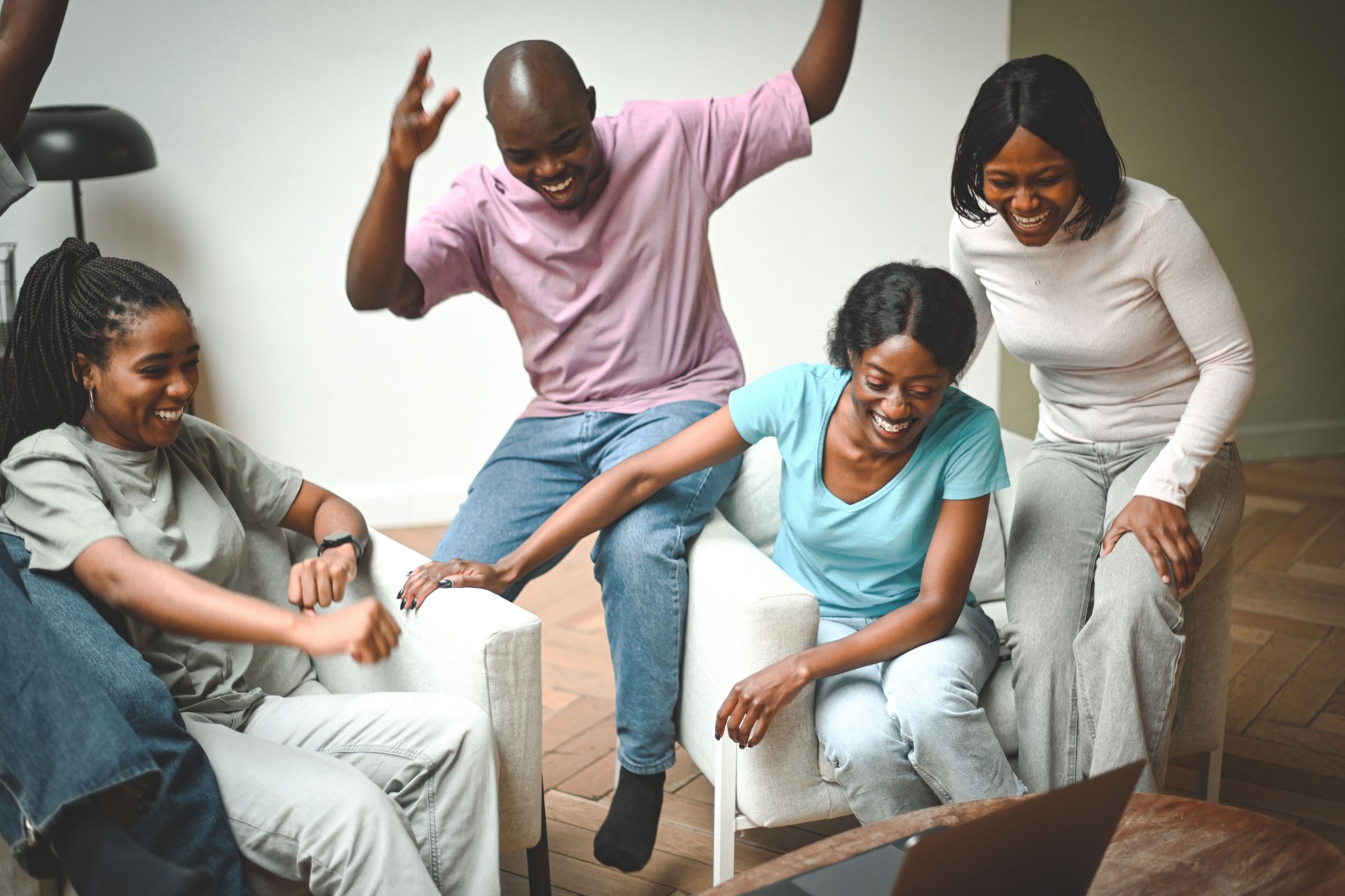 Group of friends watching a championship or a movie on a laptop